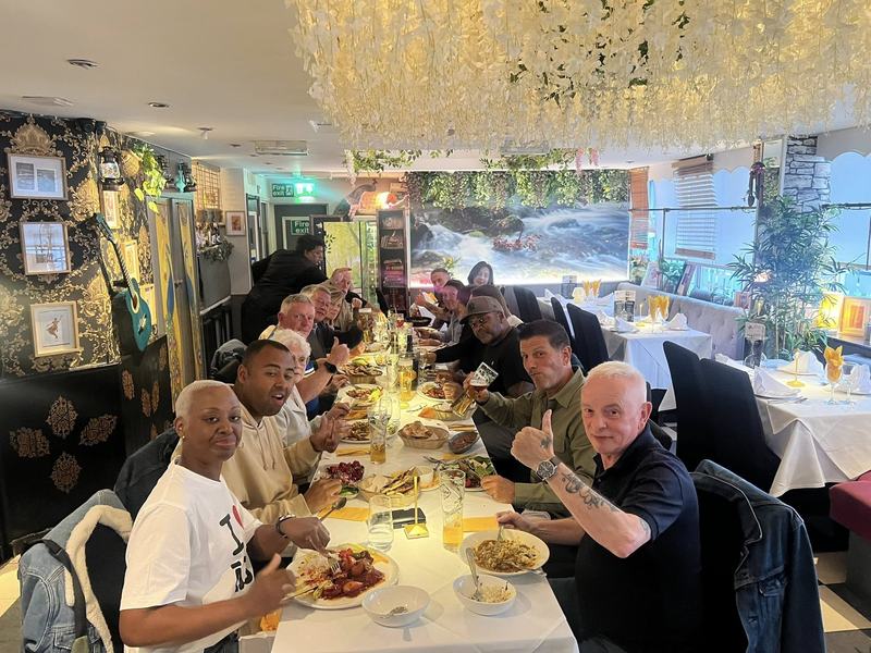A large party dining together at a long table