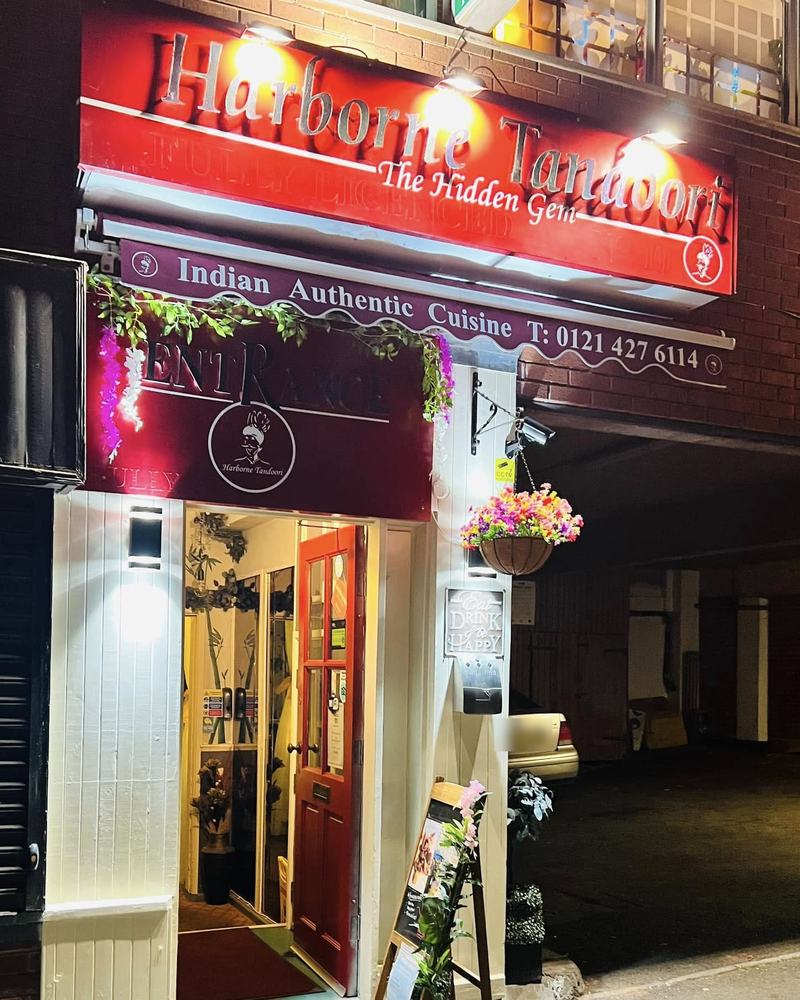 The Harborne Tandoori entrance on South Street, lit up at night